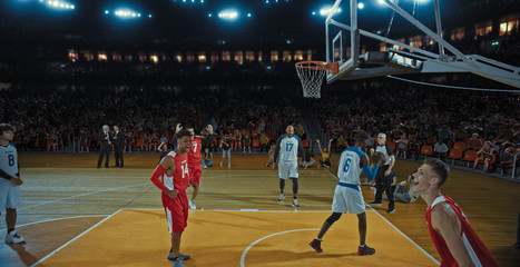 Fototapeta premium Basketball players on big professional arena during the game. Tense moment of the game. Celebration