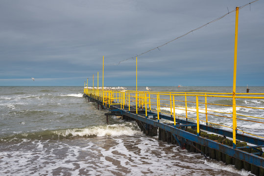 Yellow jetty and Baltic Sea on a cloudy day. Jaroslawiec, a fishing village in Poland