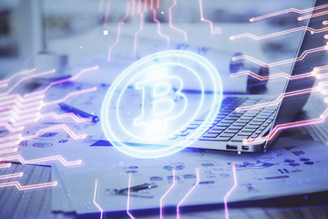 Double exposure of blockchain theme hologram and table with computer background. Concept of bitcoin crypto currency.
