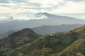 View of the Etna volcano in the clouds from Castelmola Sicily
