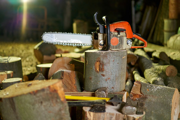 Lumberjack tools on logs in the night