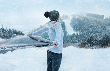 Happy woman traveler on the snowy of mountain look on the nice w