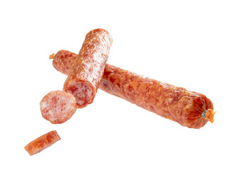 Two crossed sticks of smoked salami sausage with sliced pieces isolated on white background. 100 percent sharpness.