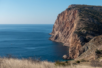 Beautiful seascape - rocky cliffs breaking into the sea at the South Coast of Crimean peninsula.