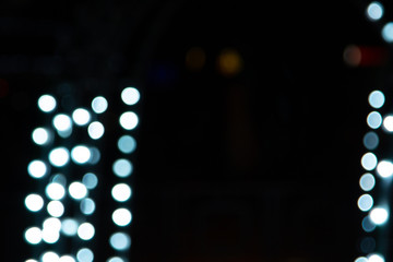 Fototapeta premium Golden abstract yellow, orange bokeh lights isolated on black background with copy space. Holiday and Christmas season concept, graphic resources, greeting card. wallpaper. Multi-colored lights.