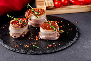 Raw meat, semifinished. Marinated beef steak wrapped in bacon with spices. Copy space, background image