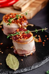 Raw meat, semifinished. Marinated beef steak wrapped in bacon with spices. Copy space, background image
