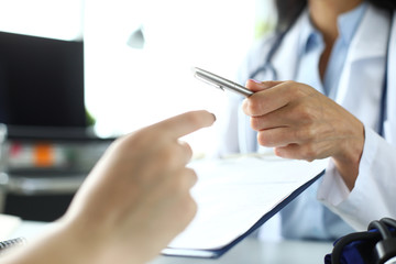 Fototapeta premium Hand of female GP passing to patient silver pen