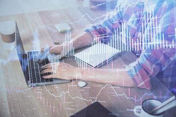 Multi exposure of forex graph with man working on computer on background. Concept of market analysis.