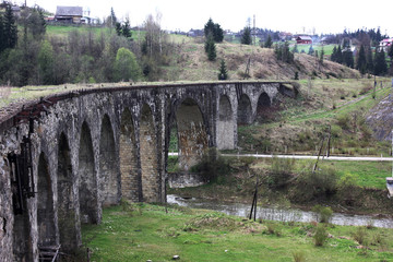 Fototapeta na wymiar Historic stone bridge in the mountains