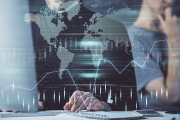 Forex graph with businessman typing on computer in office on background. Concept of analysis. Double exposure.