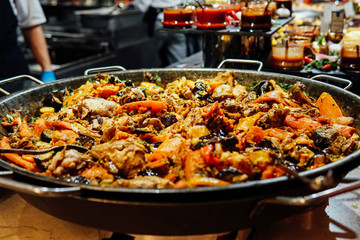 Fried meat with vegetables in a cauldron on the fire