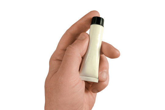 Man hand holds tube with cream, gel or paste. Mock-up on white isolated background. Middle aged man body care concept closeup image