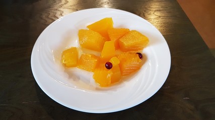 Dessert on a white plate of delicious and healthy pickled pumpkin slices