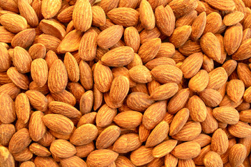 Background of almond nuts. Healthy snack and food. Salted and roasted bbq almonds. Top view. 