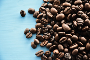 Coffee beans isolated on blue wood background