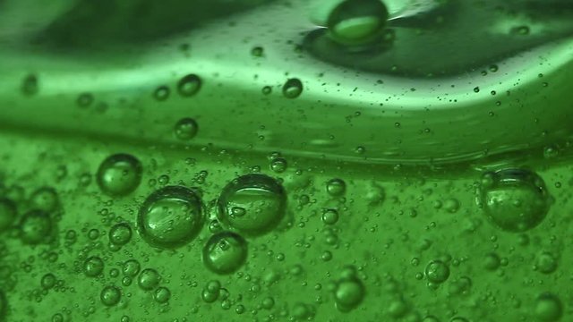 Macro of a green gel and its bubbles. Jelly. Chemistry.