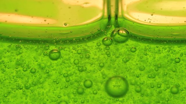 Macro of a green gel and its bubbles. Jelly. Chemistry.