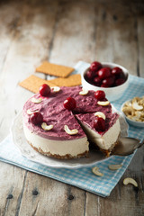Raw vegan cheesecake with cherry and cashew nuts
