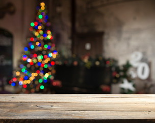 Fototapeta na wymiar Empty table in front of christmas tree with decorations background. For product display montage.