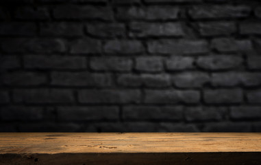 Wood table in front of rustic brick wall blur background with empty copy space on the table for...