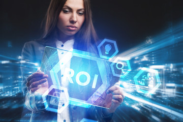 Business, Technology, Internet and network concept. Young businessman working on a virtual screen of the future and sees the inscription: ROI
