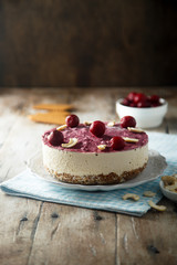 Raw vegan cheesecake with cherry and cashew nuts