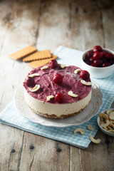 Raw vegan cheesecake with cherry and cashew nuts