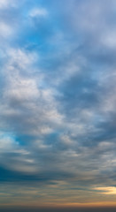 Fantastic clouds at sunrise, vertical panorama