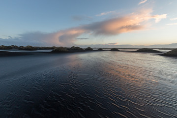 Iceland, Vestrahorn mount and black sand over the ocean.