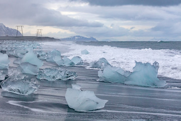 Glacier ice floating on the water with snow at glacier lagoon in the winter time in Iceland.