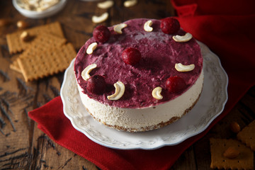 Raw vegan cheesecake with cherry and cashew nuts