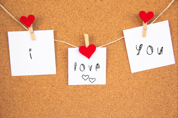 i love you red heart note on cork board