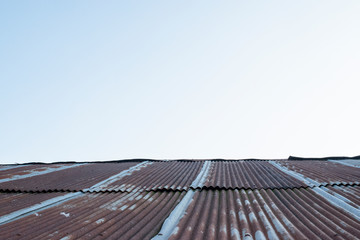 Old zinc rust roof and blue sky background