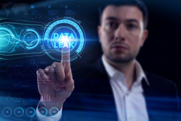 Business, Technology, Internet and network concept. Young businessman working on a virtual screen of the future and sees the inscription: Data leak