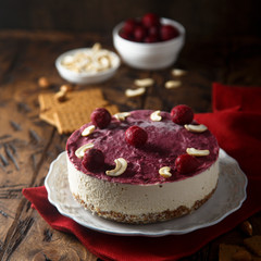 Raw vegan cheesecake with cherry and cashew nuts