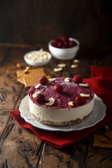 Raw vegan cheesecake with cherry and cashew nuts