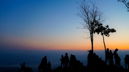 Fototapeta na wymiar A group of tourists on Doi Inthanon, Thailand, watching the sunrise in the morning.