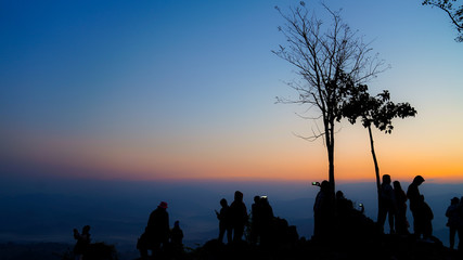 A group of tourists on Doi Inthanon, Thailand, watching the sunrise in the morning.