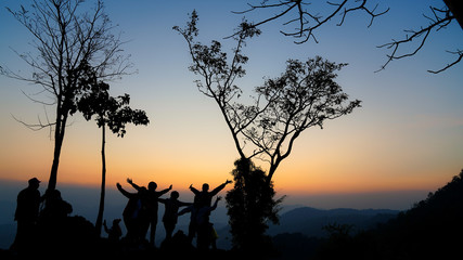 Fototapeta na wymiar A group of tourists on Doi Inthanon, Thailand, watching the sunrise in the morning.