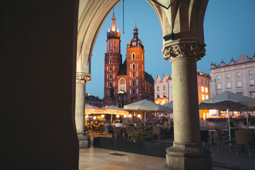 Nigt view of the main square and old town architecture. travel and tourism concept, central market square of Krakow, Poland Bazylika Mariacka. Romantic atmosphere. Copy space