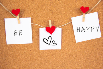 be happy red heart note on cork board
