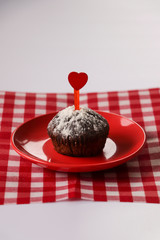 cake and heart on a red plate