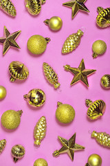 Glossy golden Xmas tree decorations background. Vintage shiny Christmas ornaments on magenta. Old fashioned star shaped toys, baubles and cones. Horizontal New Year decorative backdrop for banner.