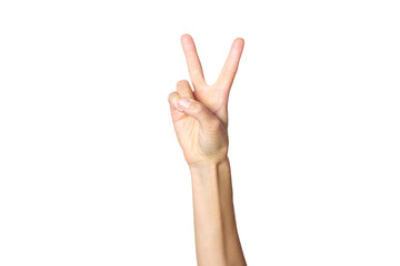 Female hand shows a gesture on a white isolated background. Two fingers up. Number two