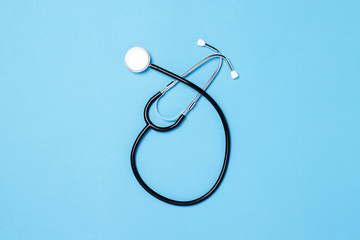 Doctor's stethoscope on a blue background. Concept medicine, vaccine, virus, epidemic. Flat lay, top view