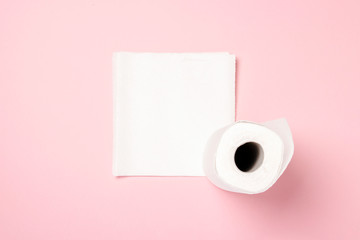 Roll of paper towels on a pink background. Concept is 100 natural product, delicate and soft. Flat lay, top view. Banner
