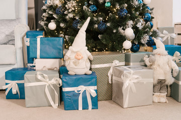 Christmas gifts and gnome under the tree, decor, selective focus