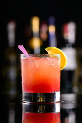 orange-red cocktail with lime