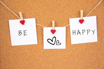 be happy red heart note on cork board